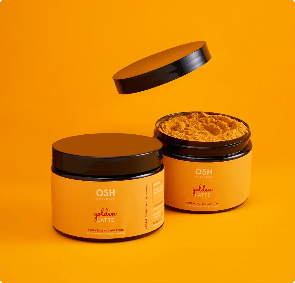 Two yellow jars of "Golden Latte" powder with black lids on a yellow background. One lid is floating above the jar.