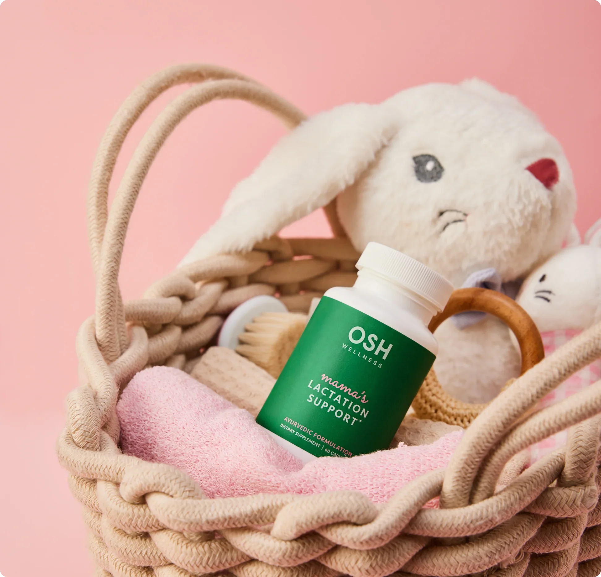 OSH Wellness supplement bottle in a basket with plush toys on a pink background