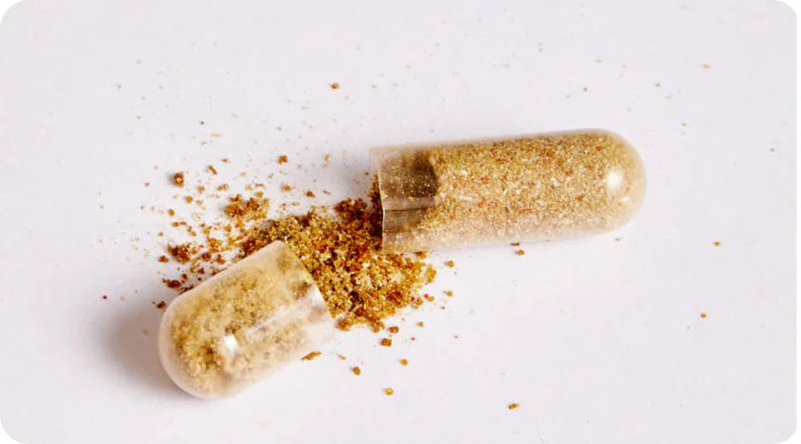 Open capsule pill with powder inside.